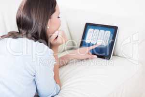 Composite image of woman touching her digital tablet