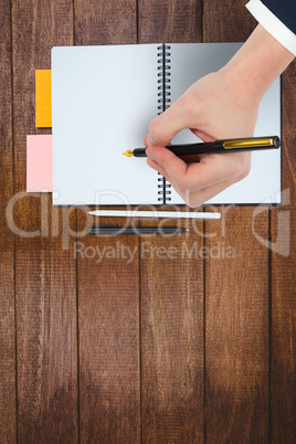 Composite image of hand holding a fountain pen