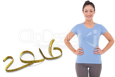 Composite image of fit brunette smiling at camera