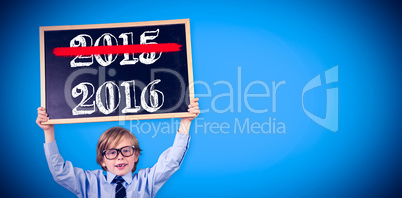 Composite image of cute pupil holding chalkboard