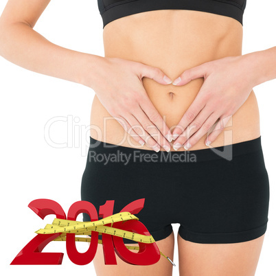 Composite image of closeup mid section of a fit woman in black s