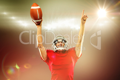 Composite image of american football player with holding ball ar