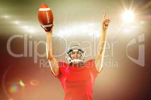 Composite image of american football player with holding ball ar