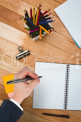 Composite image of hand writing with a pen