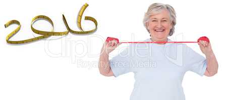 Composite image of senior woman using resistance band