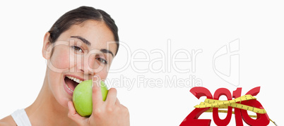 Composite image of close up a brunette eating a green apple