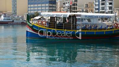 The traditional Maltese boat and view on Sliema, Malta