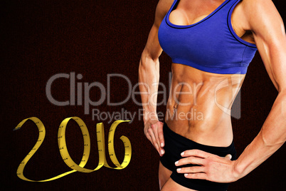 Composite image of midsection of fit woman with hand on hip