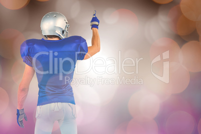 Composite image of rear view of sports player pointing