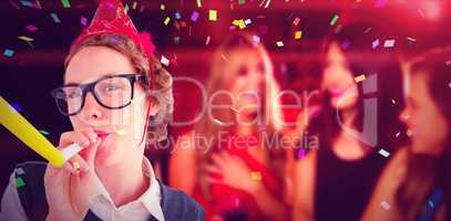 Composite image of geeky hipster wearing a party hat wig blowing