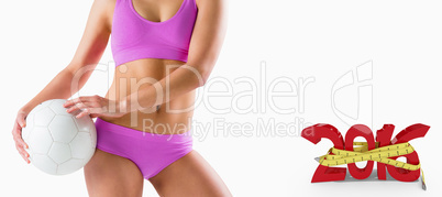 Composite image of fit girl in pink bikini holding ball