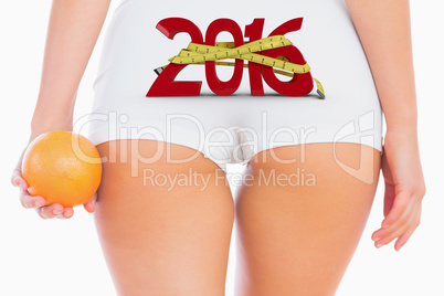 Composite image of midsection of woman holding orange