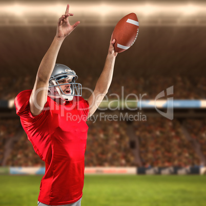 Composite image of american football player holding ball while pointing up