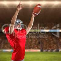 Composite image of american football player holding ball while pointing up