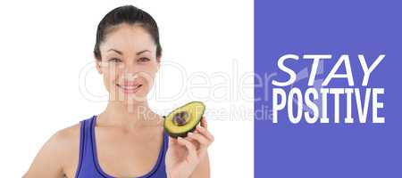 Composite image of pretty woman showing half of an avocado