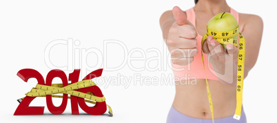 Composite image of slim woman holding apple with measuring tape