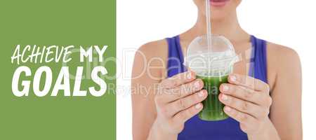 Composite image of woman showing green juice in goblet