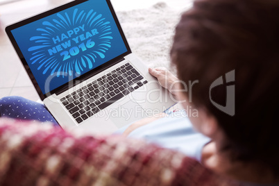 Composite image of pregnant woman using her laptop