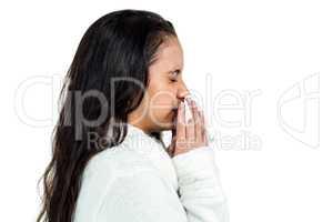 Attractive woman blowing her nose
