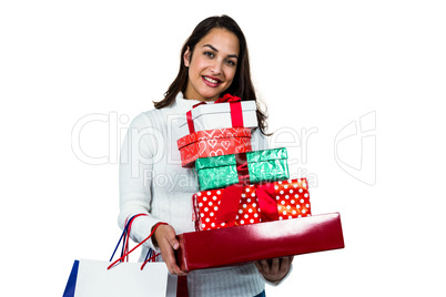 Festive brunette smiling with gifts