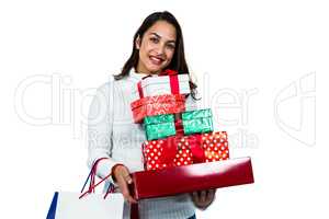 Festive brunette smiling with gifts