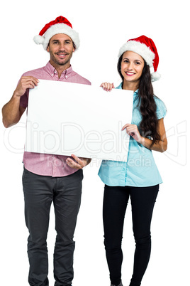 Festive couple showing a sign