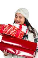Smiling woman holding red and white gift boxes