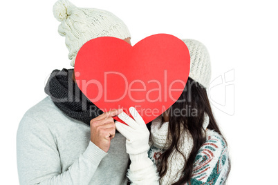 Smiling couple holding paper heart