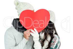 Smiling couple holding paper heart