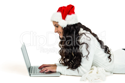 Smiling woman laying on floor using laptop