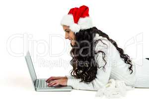 Smiling woman laying on floor using laptop