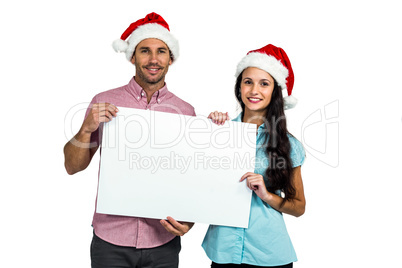 Festive couple showing a sign