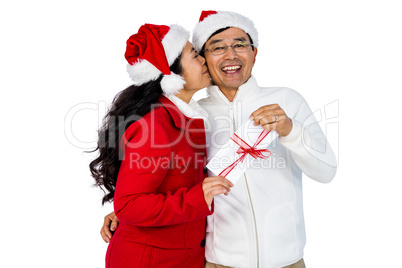Festive senior couple exchanging gifts