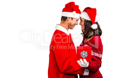 Festive couple exchanging a gift