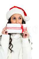 Attractive woman covering mouth with gift box