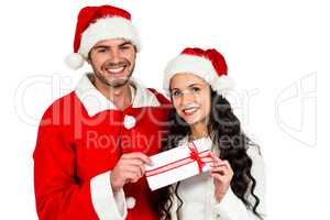 Couple with christmas hats holding gift box