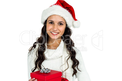 Smiling woman with christmas hat holding gift
