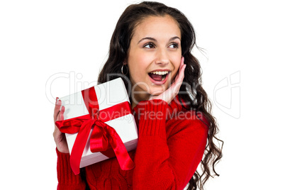 Festive brunette holding a gift