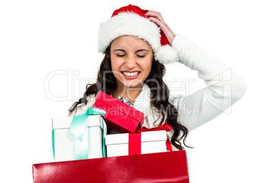 Attractive woman with christmas hat holding gifts