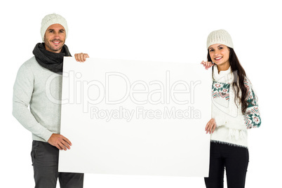 Smiling couple holding white sheet