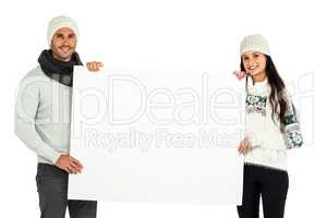 Smiling couple holding white sheet