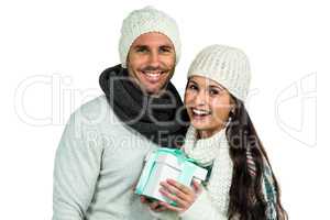 Smiling couple holding gift box