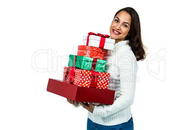 Festive brunette smiling with gifts