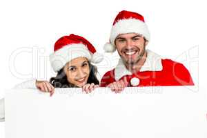 Festive couple showing a poster
