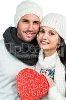 Smiling couple holding gift box