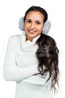 Smiling woman with earmuffs crossing arms