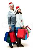 Festive couple smiling and holding gift bags