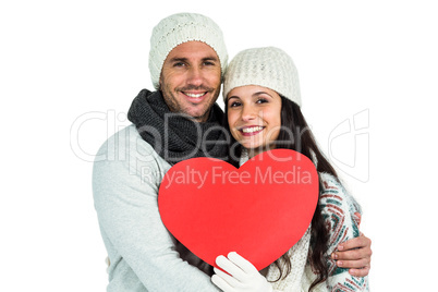 Smiling couple holding paper heart