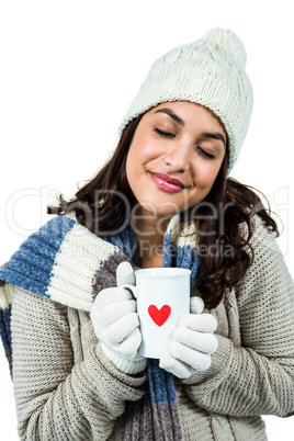 Festive brunette holding hot drink