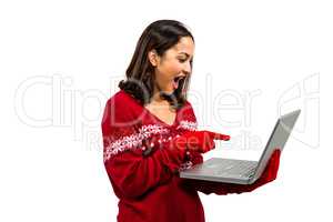 Festive brunette using her laptop